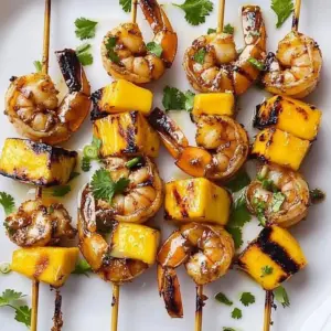 Grilled mango shrimp skewers on a barbecue grill
