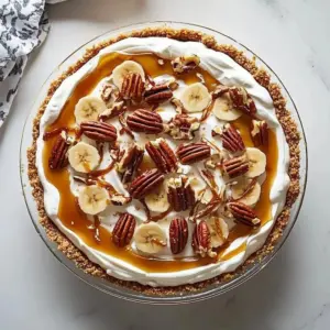 No-Bake Banana Caramel Pecan Pie with caramel drizzle and pecans